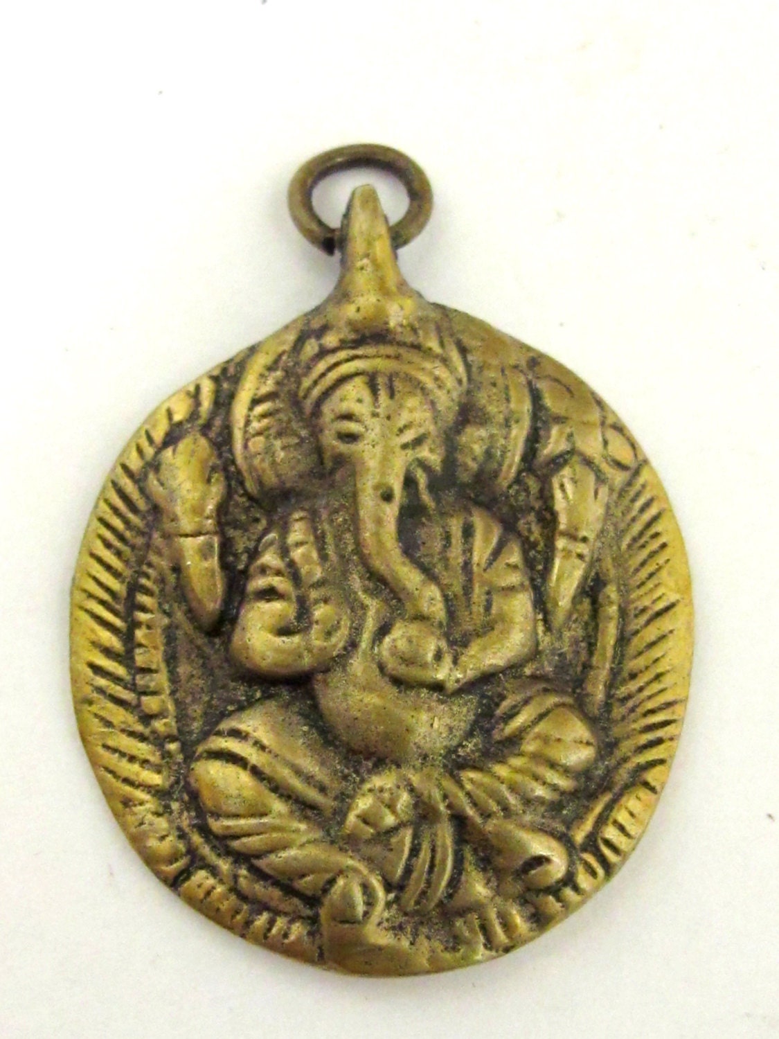 Oval Shape Seated four armed Ganesha brass charm pendant from Nepal - CP054
