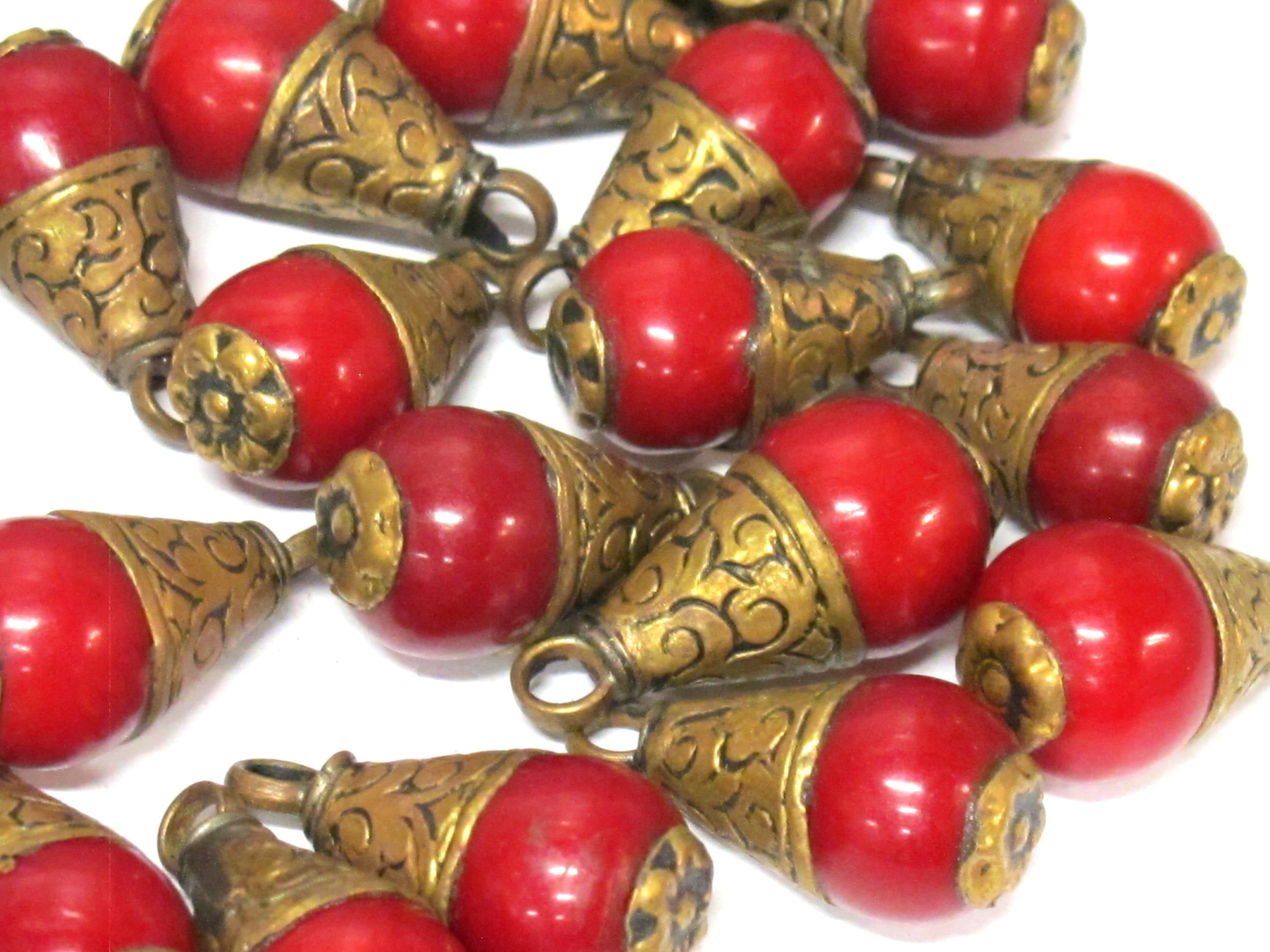 Tibetan brass capped red resin small size drop pendant with floral design on bail -- PM568A
