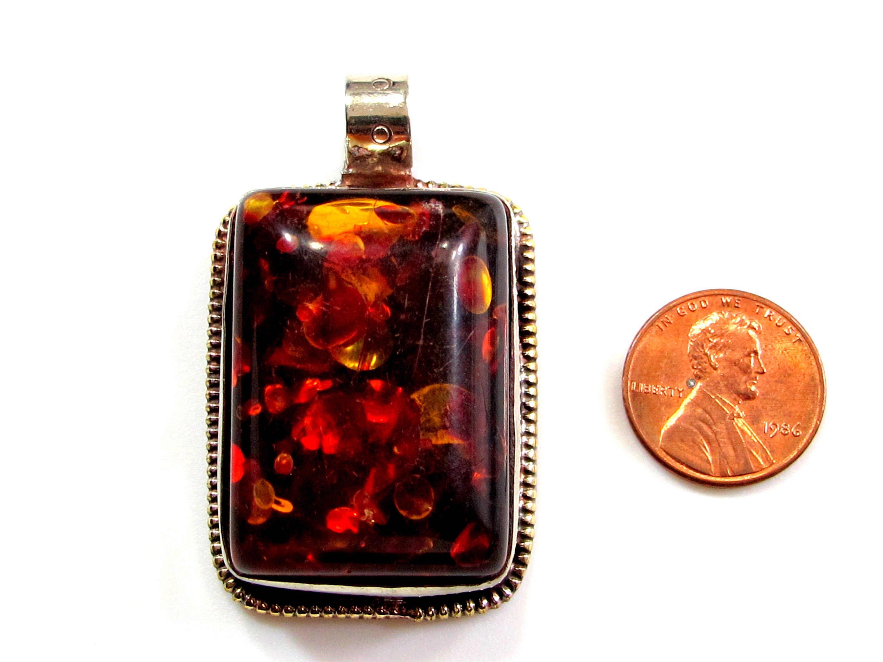 Beautiful Tibetan honey color resin pendant with floral design on reverse side Tibetan pendant Nepal jewelry supply nepalbeadshop PM704A