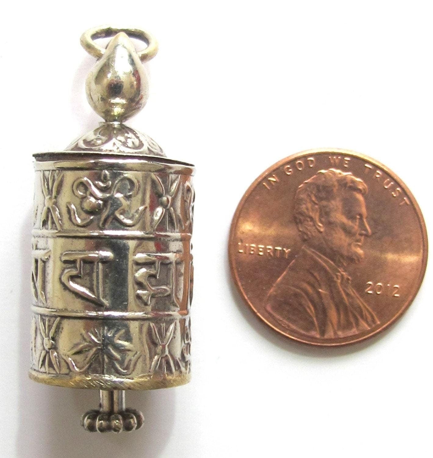 Tibetan antiqued silver Om Mantra with auspicious symbols spinnable prayer wheel scroll pendant light-weight Nepal - SP022