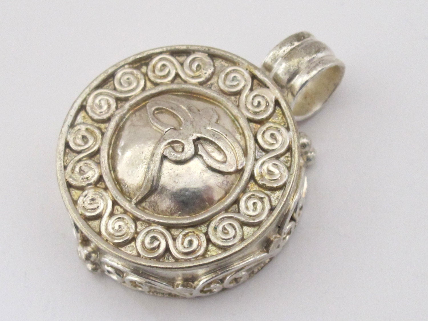 Round shape Tibetan antiqued silver finish Ghau prayer box pendant with buddha eyes symbol and double spiral design - PM191H