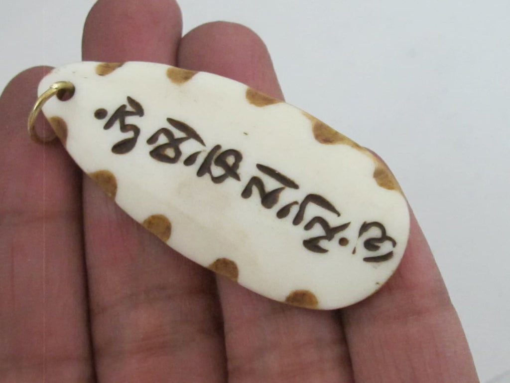 Carved recycled cattle bone Tibetan Om mantra inscribed leaf shape pendant - PB077