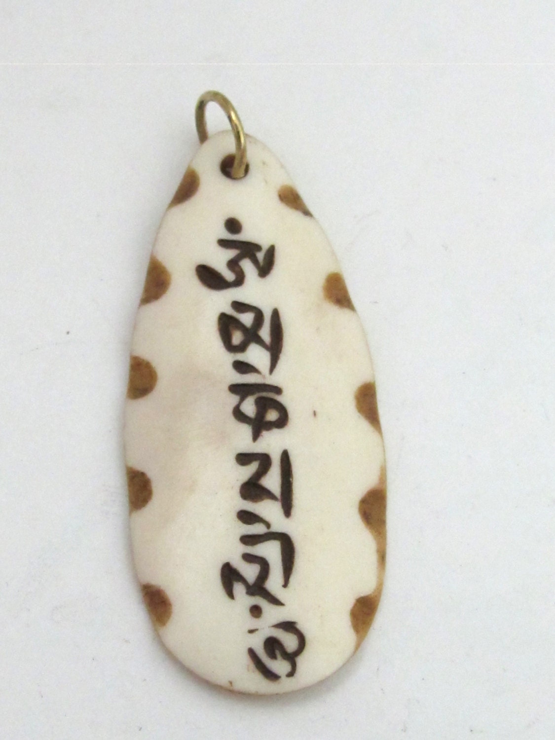 Carved recycled cattle bone Tibetan Om mantra inscribed leaf shape pendant - PB077