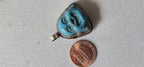 Tibetan antiqued silver color encased turquoise howlite happy Buddha face focal pendant floral carving - PM001A