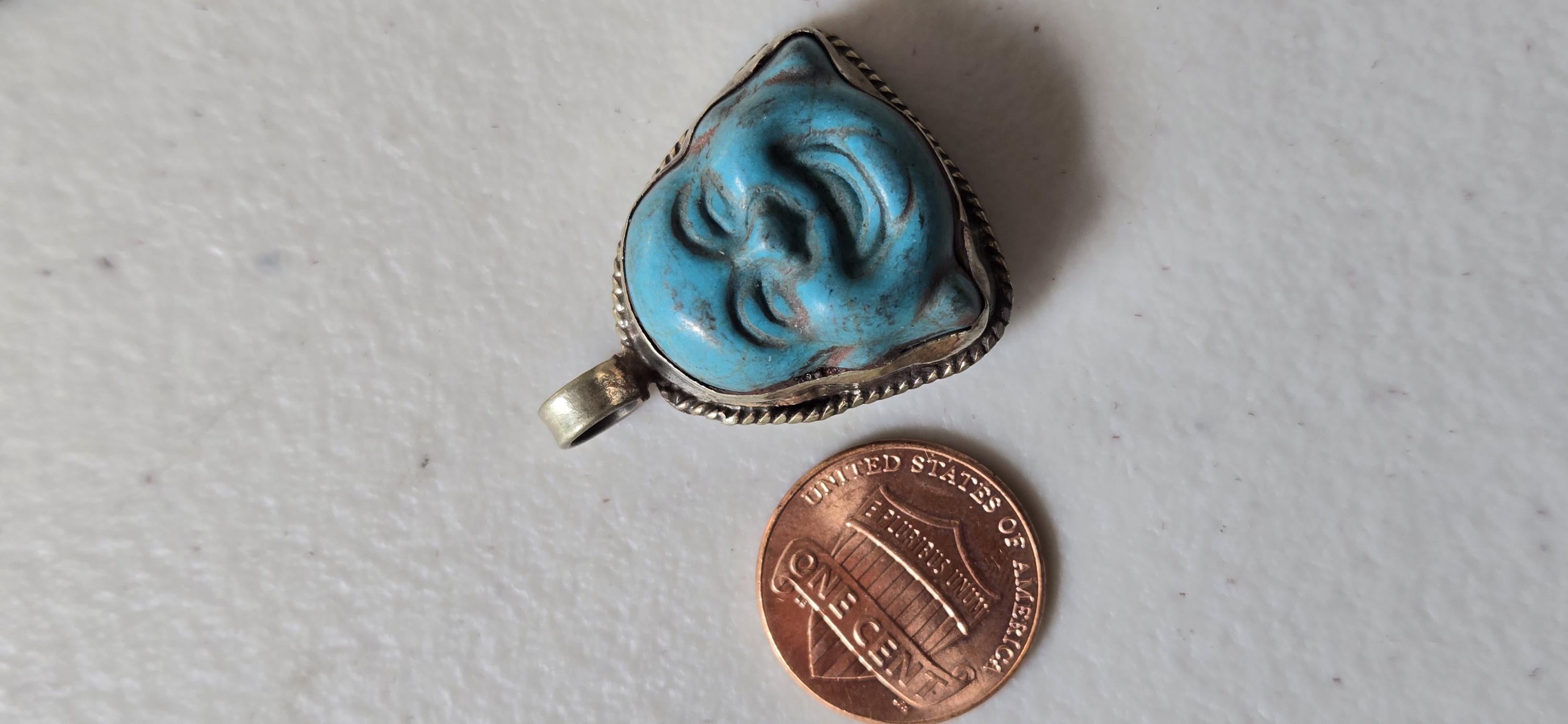Tibetan antiqued silver color encased turquoise howlite happy Buddha face focal pendant floral carving - PM001A