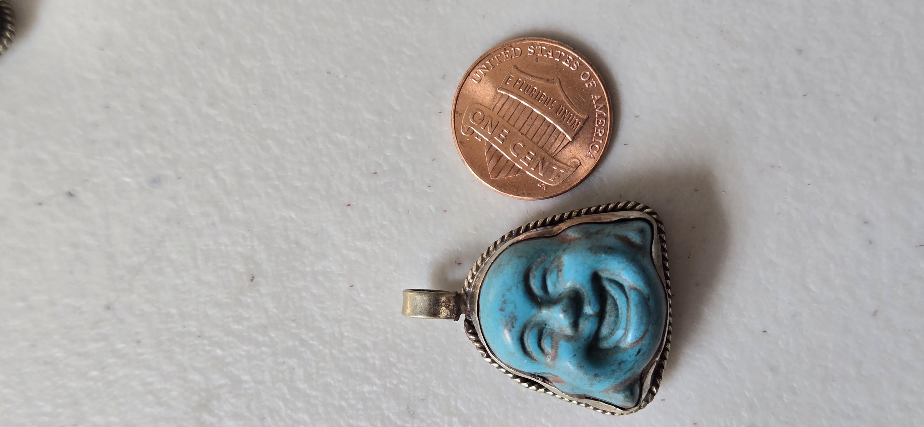 Tibetan antiqued silver color encased turquoise howlite happy Buddha face focal pendant floral carving - PM001A