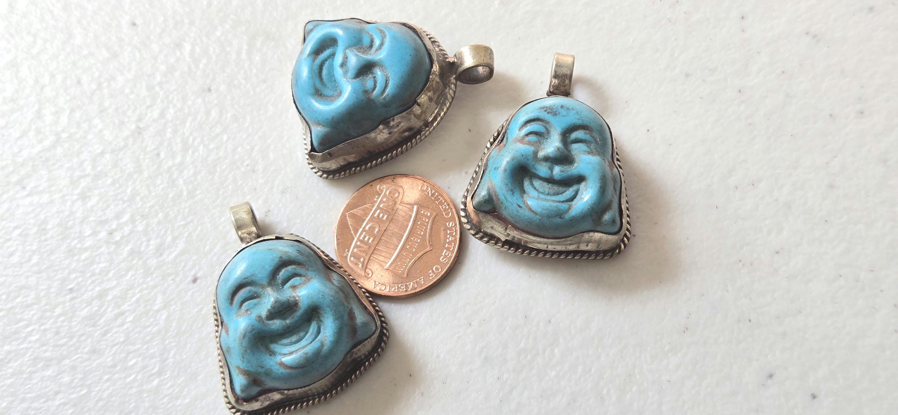 Tibetan antiqued silver color encased turquoise howlite happy Buddha face focal pendant floral carving - PM001A