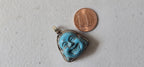 Tibetan antiqued silver color encased turquoise howlite happy Buddha face focal pendant floral carving - PM001A