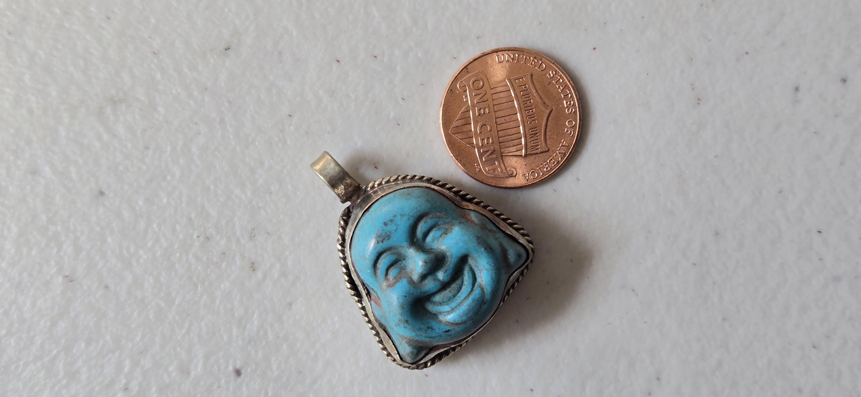 Tibetan antiqued silver color encased turquoise howlite happy Buddha face focal pendant floral carving - PM001A