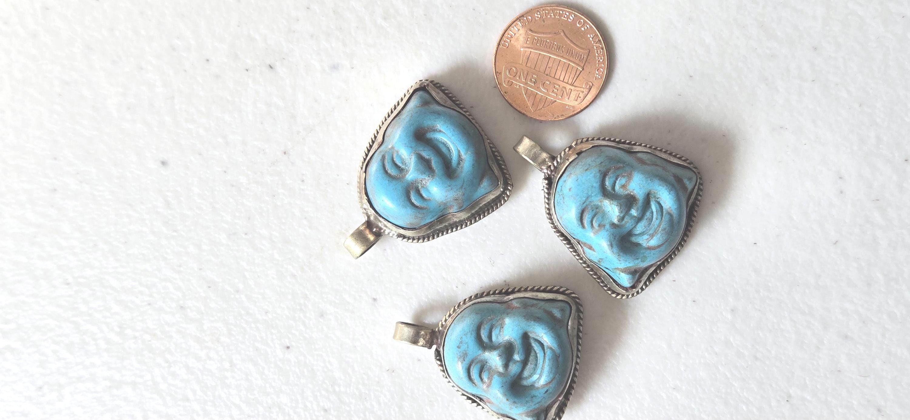 Tibetan antiqued silver color encased turquoise howlite happy Buddha face focal pendant floral carving - PM001A