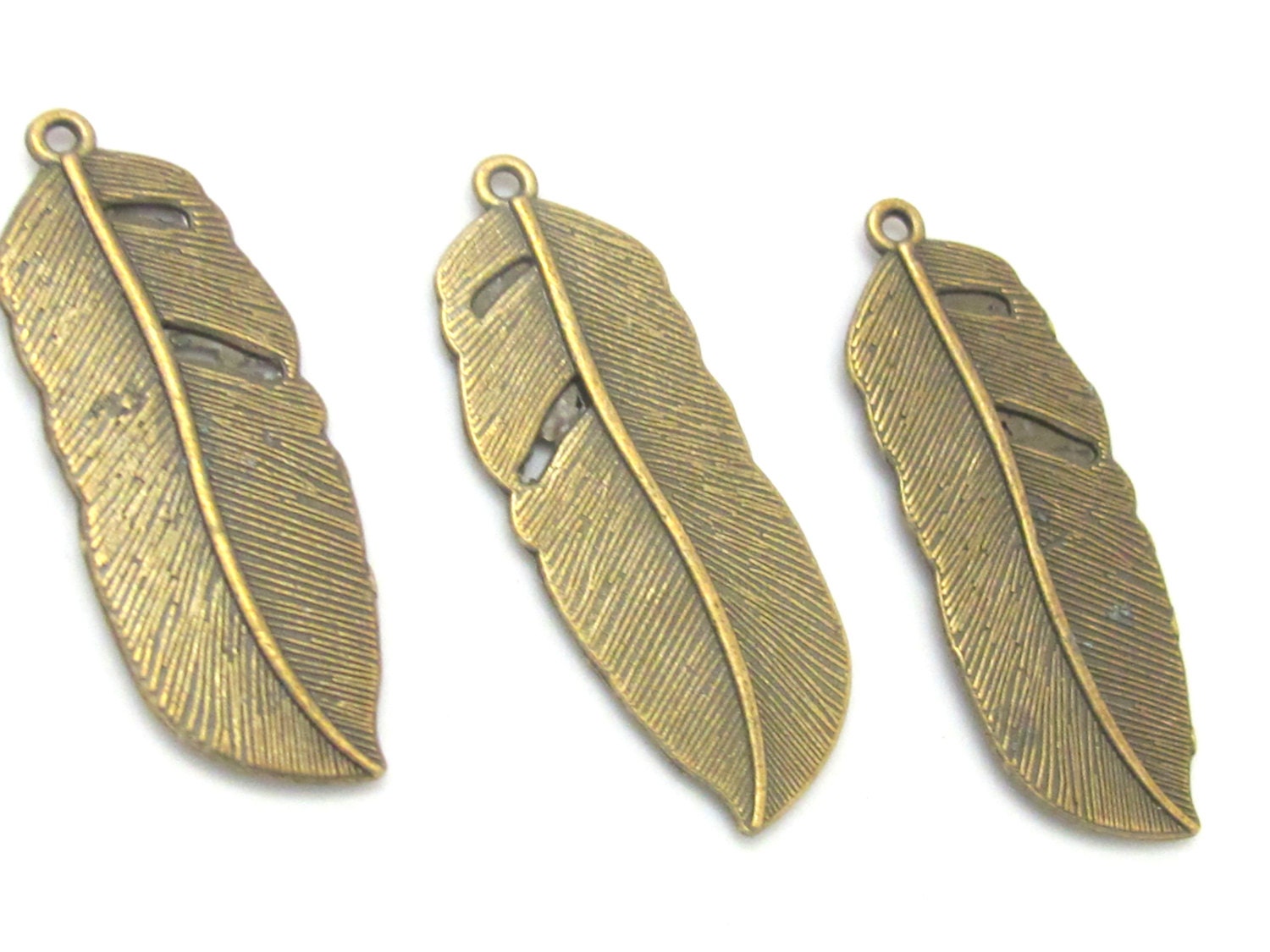 4 Large Brass tone feather charms 43 mm x 15 mm - CM092