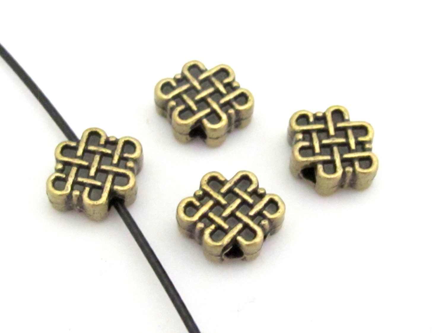 6 Beads - Reversible Tibetan infinity knot symbol brass tone small size beads 11 mm x 9 mm - BD668