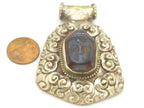 Tibetan silver blue Buddha pendant with floral repousse details - PM336B