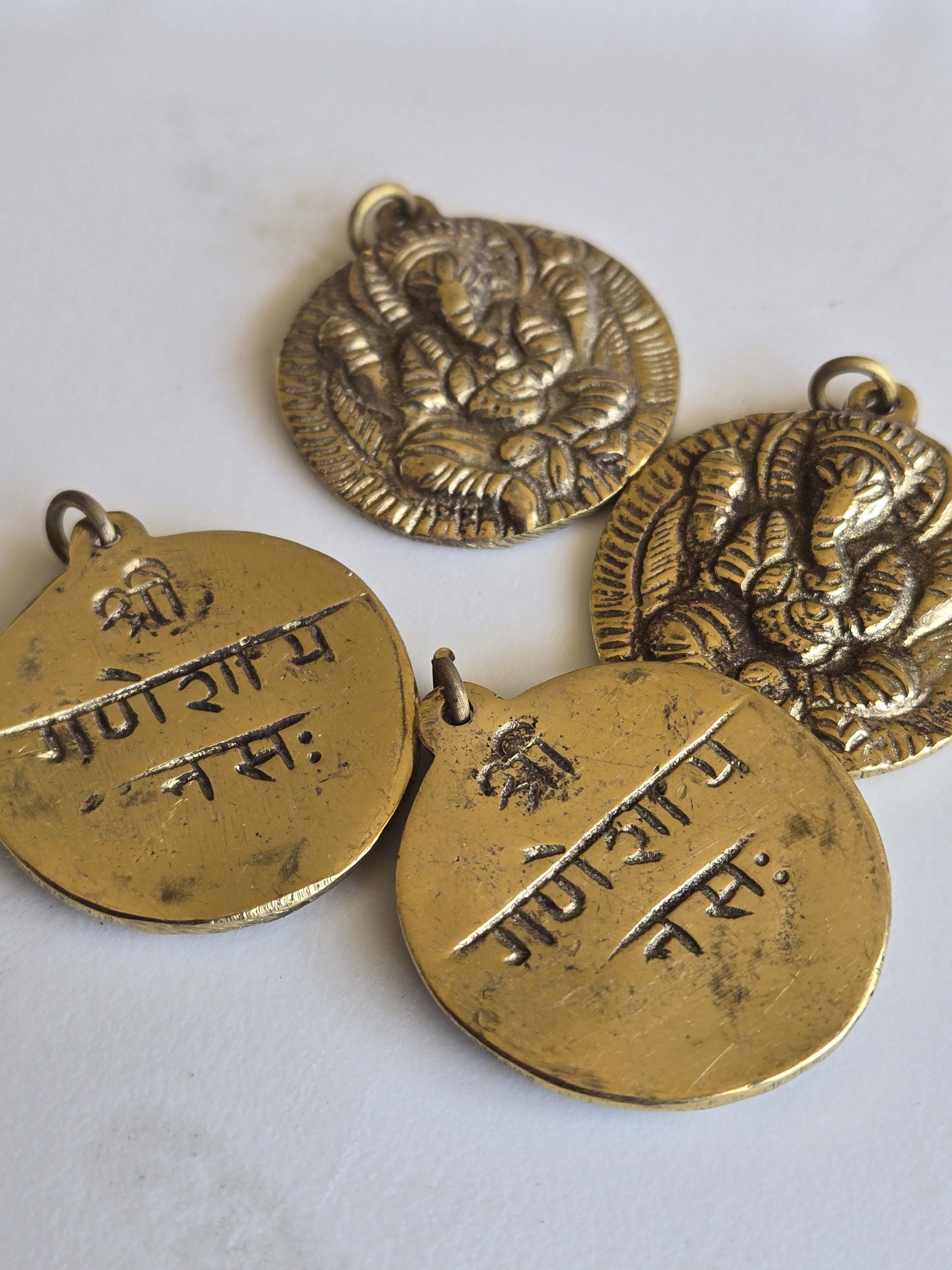 Oval Shape Seated four armed Ganesha brass charm pendant from Nepal - CP054