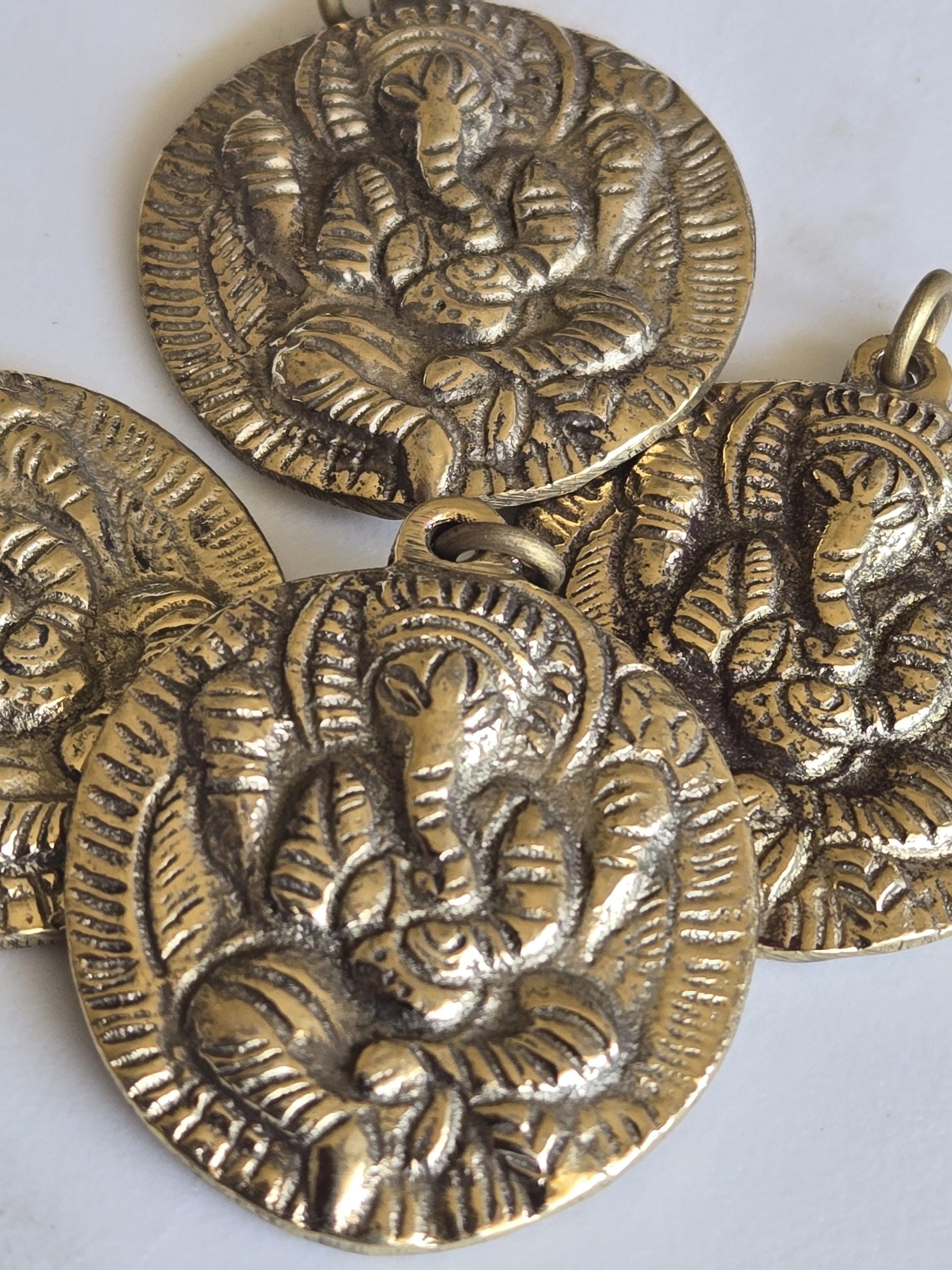 Oval Shape Seated four armed Ganesha brass charm pendant from Nepal - CP054